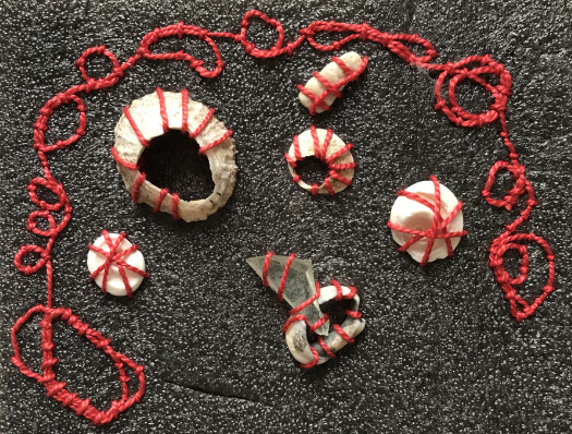 Mixed media work by Claire Baker: broken (n)aimless  Mixed media work (foam packing sheets, op-shop sourced Sylko Size A embroidery thread, Velcro adhesive dots, broken shells, pebbles, glass splinter, ink. Dimensions: 59 cm x 71 cm